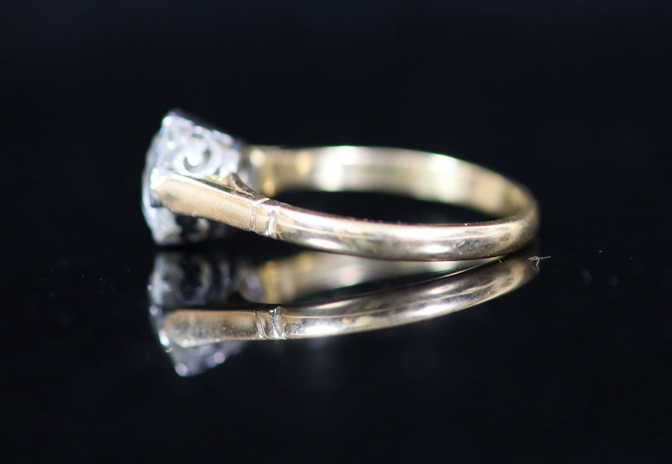 A gold and solitaire diamond ring